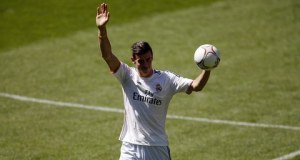 Gareth Bale of Wales waves to Real Madrid fans during his presentation at the Santiago Bernabeu stadium in Madrid